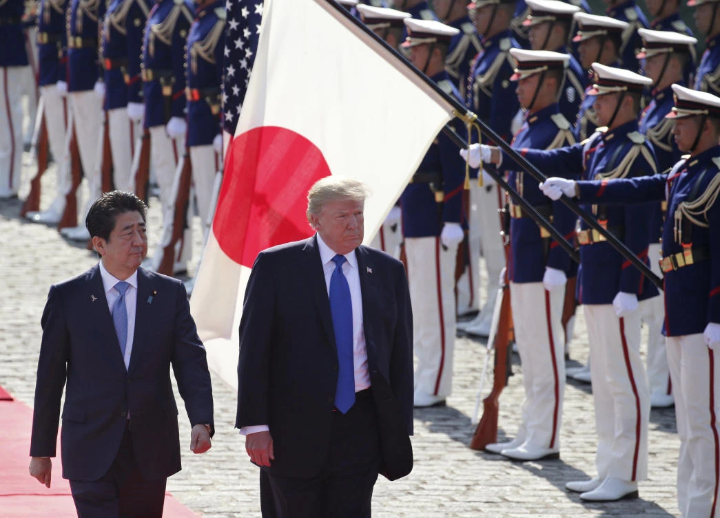 In this Nov. 6, 2017, file photo, US President Donald Trump reviews an honor guard during a welcome ceremony, escorted by Japanese Prime Minister Shinzo Abe at Akasaka Palace in Tokyo. (AP)