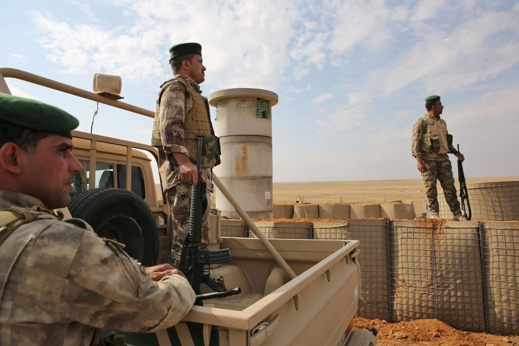 Iraqi soldiers stand guard near the Iraqi city of Qaim at the Iraqi-Syrian border. (File/AFP)