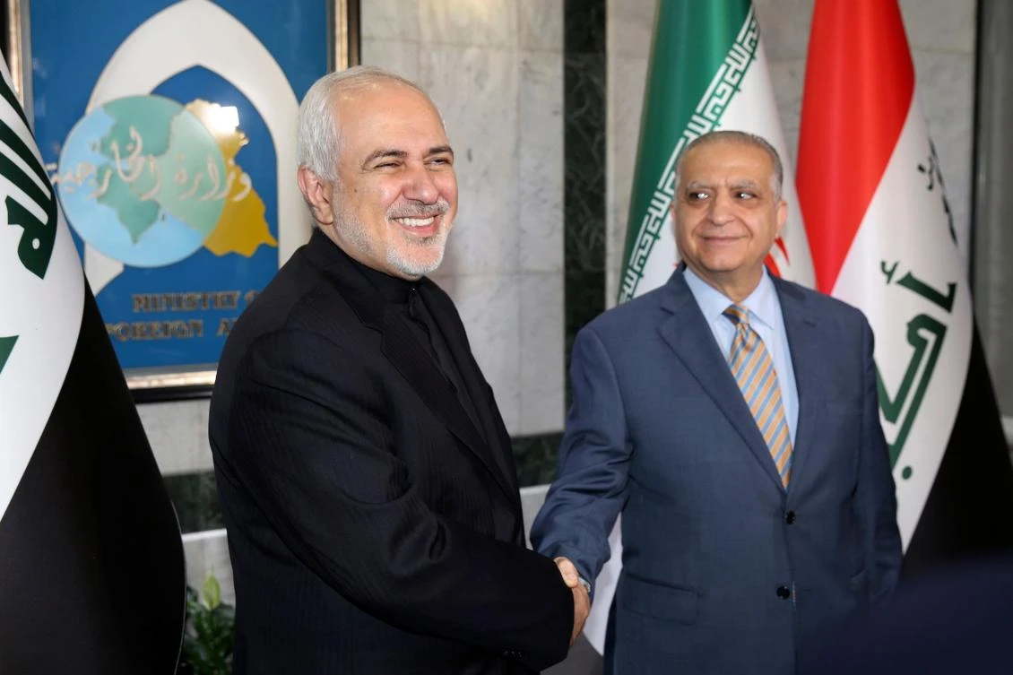 Iraqi Foreign Minister Mohammad Ali Al-Hakim, right, meets his Iranian counterpart Mohammad Javad Zarif in Baghdad on Sunday, May 26, 2019. (AFP)