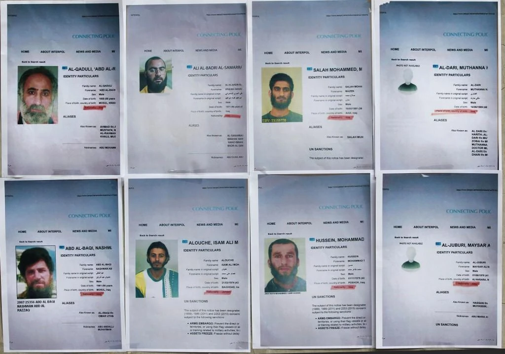 Above, printed profiles of Daesh group members – some of whom have fathered children – which were released by Iraqi authorities in this February 6, 2018 photo. (AFP)
