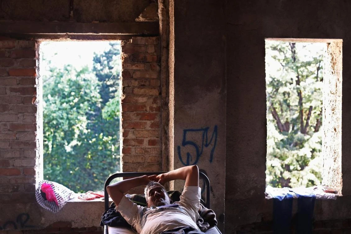 A migrant rests in a dorm destroyed during the Bosnian 1992-1995 war, in Bihac, Bosnia and Herzegovina. (Reuters)