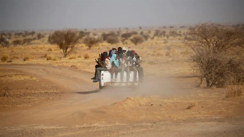 Migrants crossing the Sahara desert into Libya ride on the back of a pick-up truck outside Agadez, in central Niger. (Reuters)