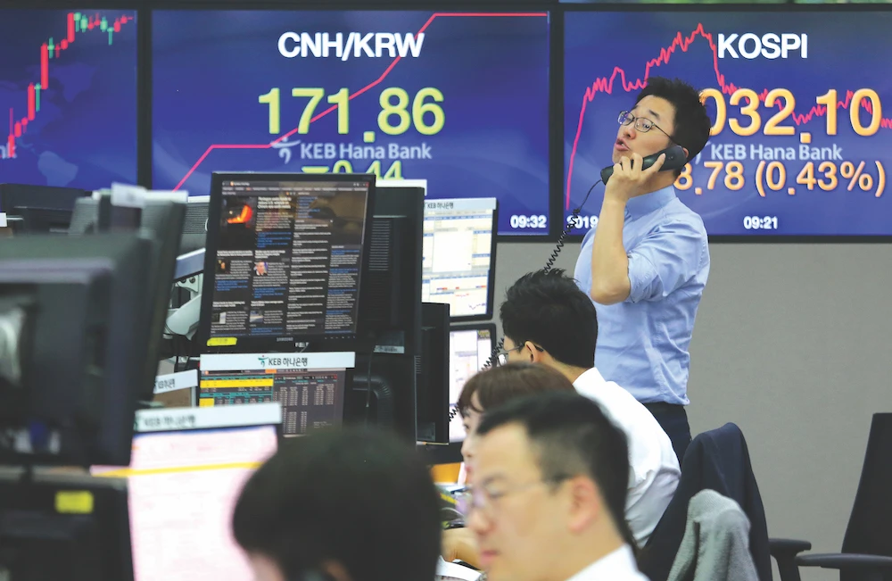 A currency trader at the foreign exchange dealing room in Seoul, South Korea. Two big crashes this year separately pummelled the yen and the Swiss franc. (AP)