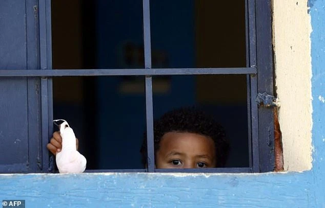 The UNHCR airlifted 149 African migrants, including 65 minors and 13 infants (similar to the child pictured in a detention centre in April 2019) from Libya to Rome for safety. (File/AFP)