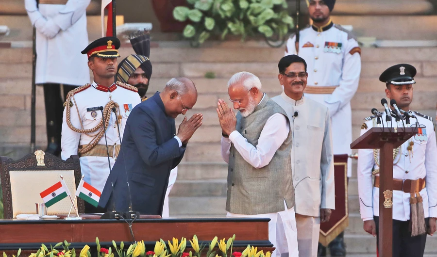Indian President Ram Nath Kovind, left, greets after administering oath to Narendra Modi, right, for a second term as India's prime minister during a swearing in ceremony at the presidential palace in New Delhi on May 30, 2019. (AP Photo/Manish Swarup)