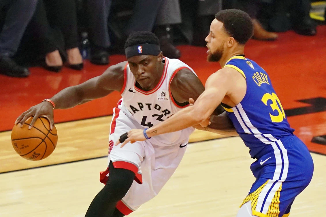 Toronto Raptors forward Pascal Siakam dribbles the ball while defended by Golden State Warriors guard Stephen Curry during the first quarter in game one of the 2019 NBA Finals at Scotiabank Arena. (USA TODAY Sports/Kyle Terada)