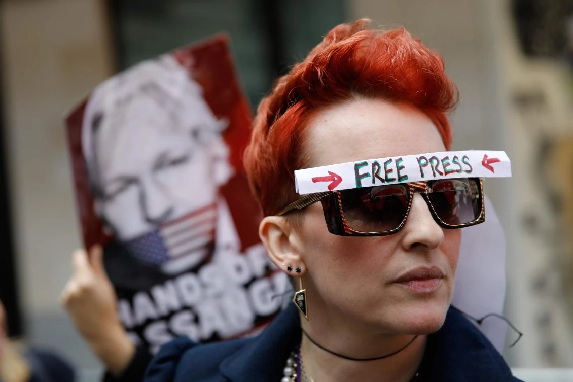 Supporters of WikiLeaks founder Julian Assange hold placards and a banners in protest outside Westminster Magistrates Court in London on May 30, 2019. (AFP)