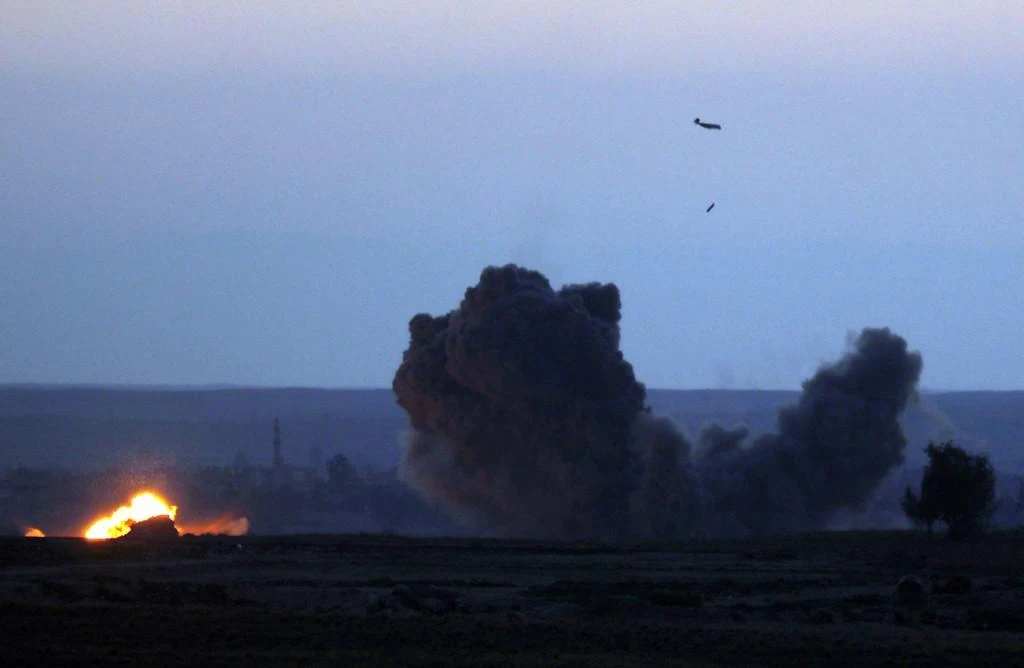 A military plane with the US-backed coalition against Daesh releases a bomb over the embattled village of Baghouz on February 19, 2019 in the northern Syrian Deir Ezzor province. (AFP)