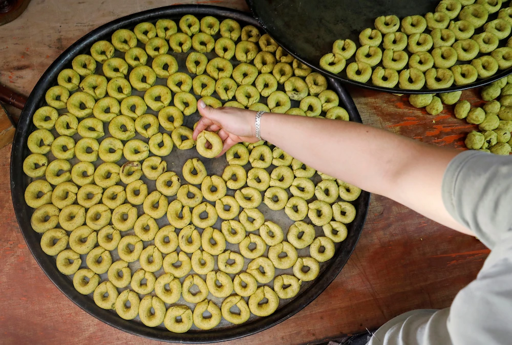 A Palestinian man prepares traditional cakes for sale ahead of Eid Al-Fitr in Nablus, the occupied West Bank. (Reuters)