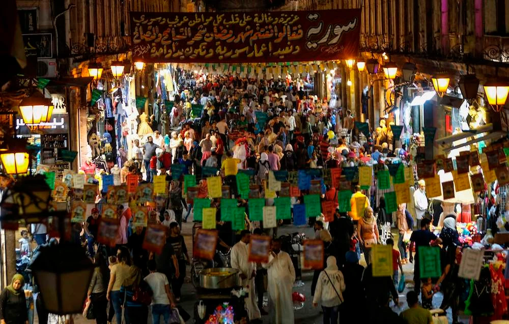 Syrians shop at the Hamidiya market ahead of Eid Al-Fitr in Damascus. (AFP)