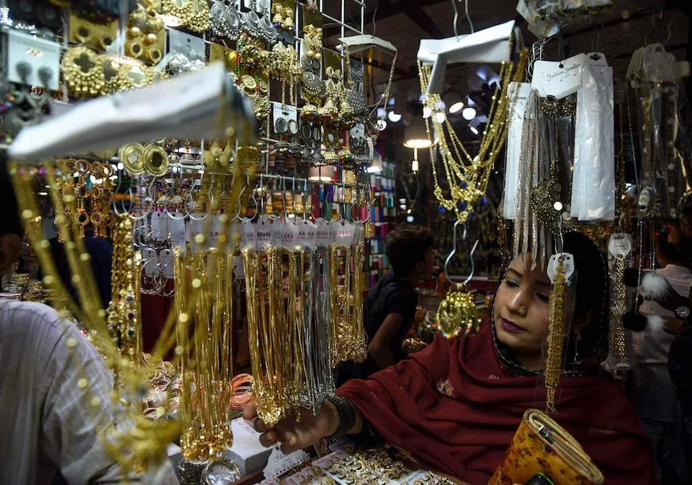 A Pakistani customer looks at jewellery at a market ahead of the Eid Al-Fitr holiday, in Karachi. (AFP)