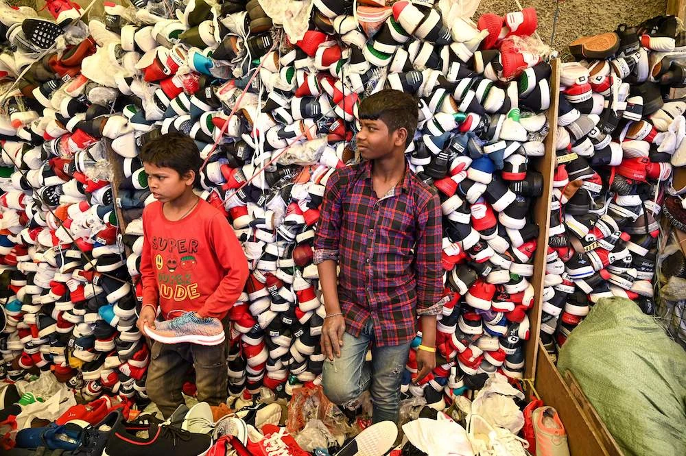 Young roadside vendors sell shoes at a market ahead of Eid Al-Fitr in Srinagar, Kashmir. (AFP)