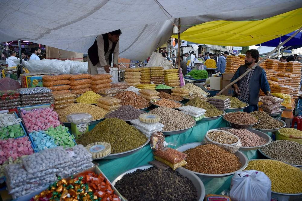 An Afghan vendor sells dry fruits and sweets ahead of the Eid Al-Fitr at a roadside stall in Kabul. (AFP)