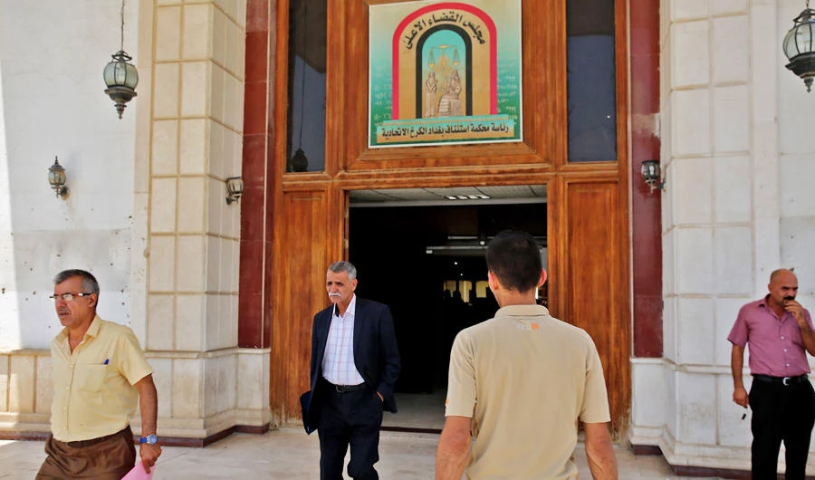 Men walk out of Baghdad's Karkh main appeals court building in the western sector of the Iraqi capital on May 29, 2019 where French jihadists accused of belonging to the Islamic state are being tried. (AFP)