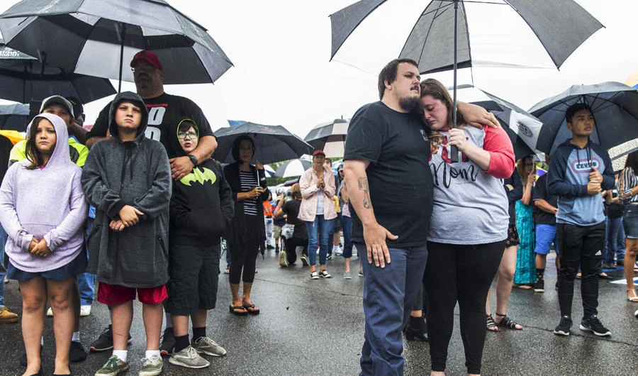 Relatives and friends attend a prayer vigil at Strawbridge Marketplace in response to a shooting at a municipal building in Virginia Beach, Vairginia, on June 1, 2019. (Daniel Sangjib Min/Richmond Times-Dispatch via AP)