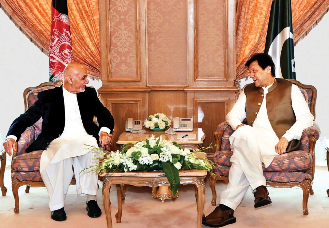Pakistani PM Imran Khan meets with Afghan President Ashraf Ghani on the sidelines of the 14th Islamic Summit in Makkah. (AFP)