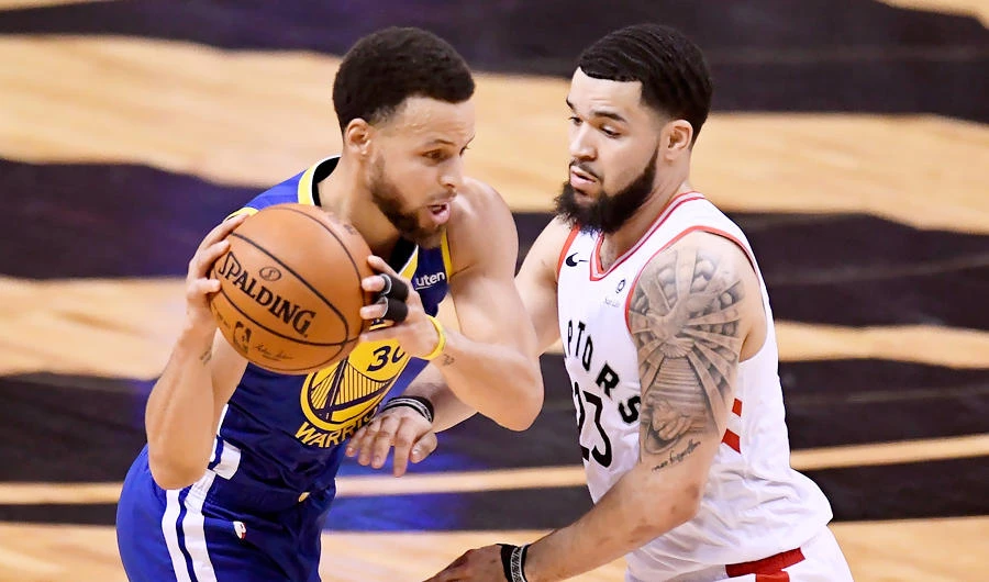 Toronto Raptors guard Fred VanVleet (23) looks on as Golden State Warriors guard Stephen Curry (30) makes a pass during the first half of Game 2 of basketball's NBA Finals, Sunday, June 2, 2019, in Toronto. (AP)