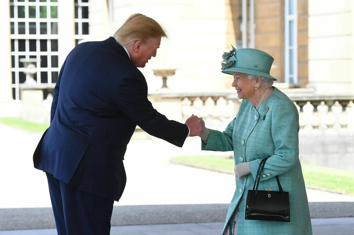 Britain's Queen Elizabeth II greets President Donald Trump as he arrives for a welcome ceremony in the garden of Buckingham Palace. (AP)