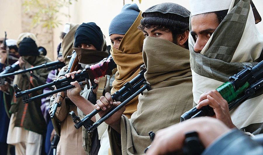 Ex-Taliban fighters holding weapons before handing them over as part of a reconciliation process with the Afghan government. (AFP)