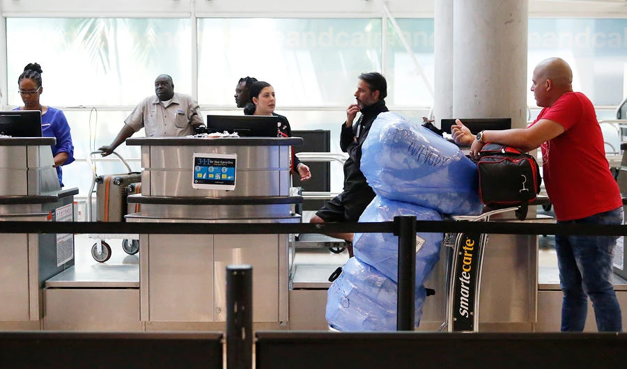 A man traveling to Cuba asks a question at the ticket counter before loading his baggage at the Fort Lauderdale-Hollywood International Airport on Tuesday, June 4, 2019, in Fort Lauderdale, Fla. (AP)