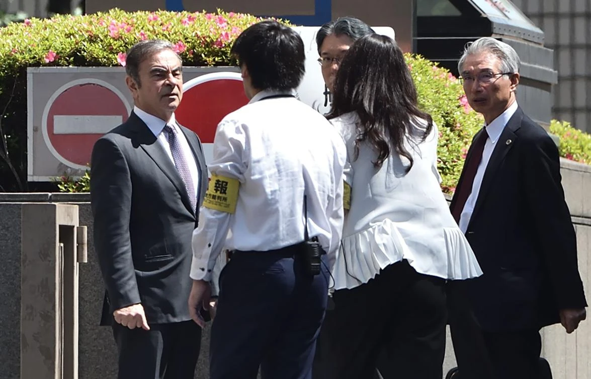Former Nissan Motor chairman Carlos Ghosn, left, arrives at the Tokyo District Court for a hearing on May 23, 2019. (AFP)