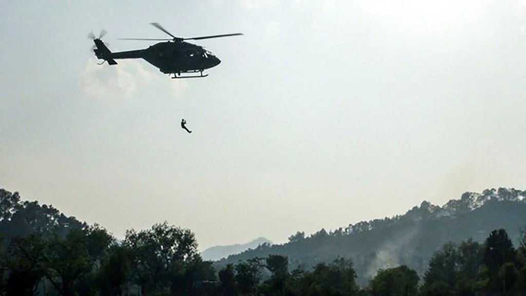 Indo-Tibetan Border Police trained mountaineers and air force personnel take part in an exercise training session with a helicopter at the Pithoragarh helipad in Uttarakhand, before going on a mission to retrieve the bodies of climbers. (AFP)
