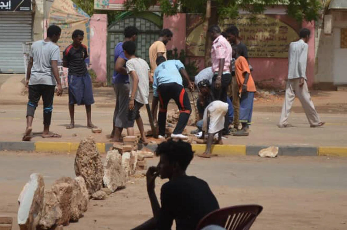 Bricks are laid by protesters to block a street in the Sudanese capital Khartoum to stop military vehicles from driving through the area on Wednesday, June 5, 2019. (AP)