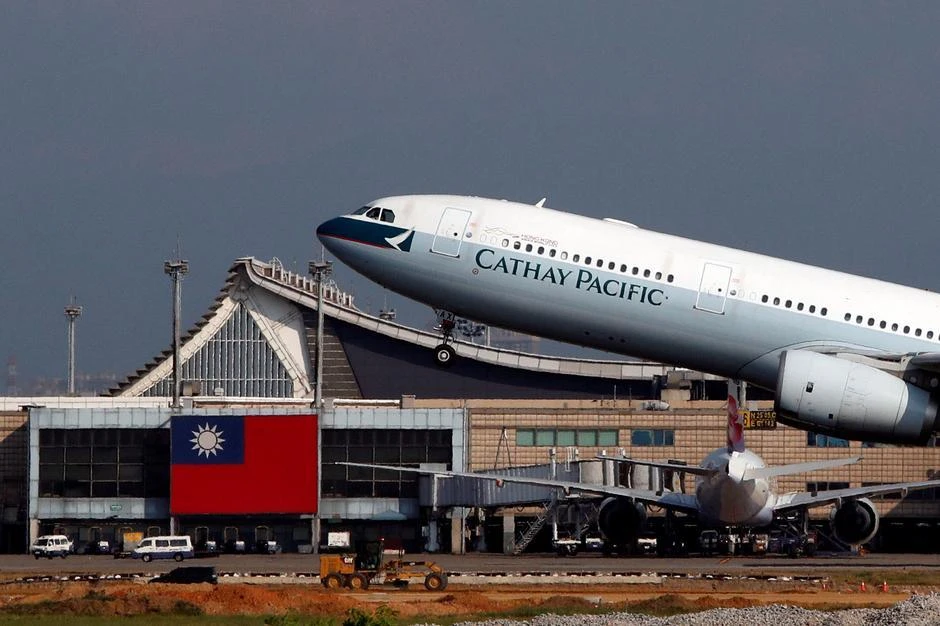 Hong Kong’s Cathay Pacific Airways Airbus A330-300 passenger plane takes off near a Taiwanese national flag at Taoyuan International Airport, Taiwan. (Reuters)