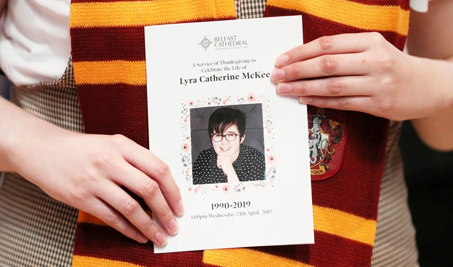 A mourner wearing a Gryffindor scarf holds an order of service as she arrives for the funeral of murdered journalist Lyra McKee at St Anne's Cathedral in Belfast, Northern Ireland April 24, 2019. (REUTERS)
