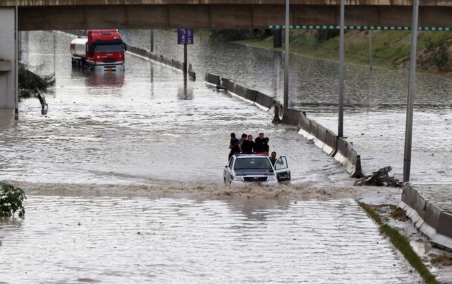 Libyan police drive through a flooded road, caused by heavy rain, in the capital Tripoli on Nov. 6, 2015. (AFP)
