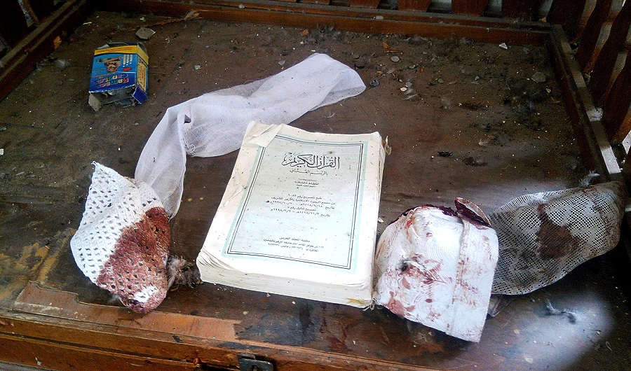 A copy of the Holy Qur’an and remnants of personal belongings of victims of the attack on the Al-Rawdah Mosque. (Reuters)