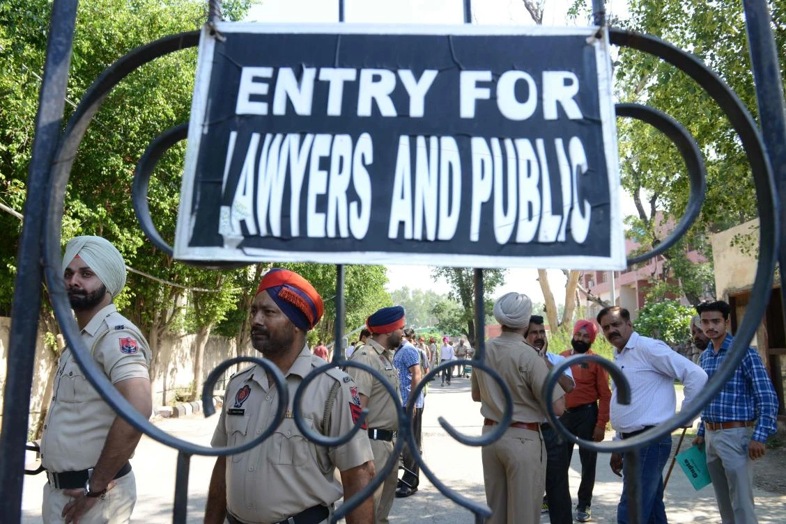 Police personnel stand guard outside a court in Pathankot, India as the verdict on the case of rape and murder of a Muslim girl is to be delivered on June 10, 2019. (AFP)