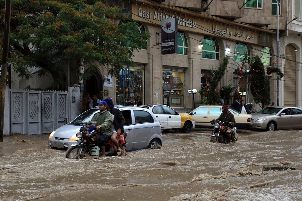 Yemeni men ride through a flooded street following heavy rainfall in the Yemeni capital Sanaa on May 26, 2019. (File/AFP)