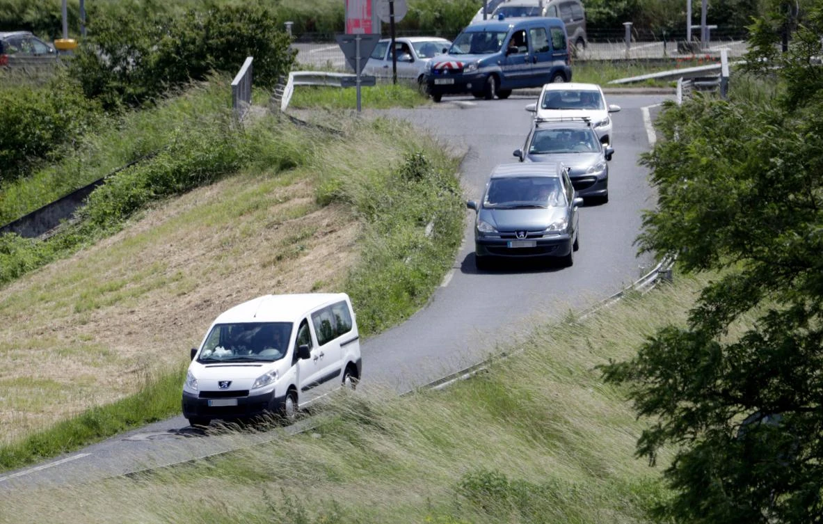 A vehicle, left, allegedly transporting orphaned children of French militants leaves the Velizy-Villacoublay airport on Monday, June 10, 2019. (AFP)