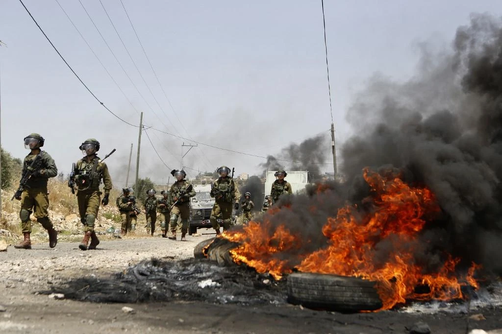 Israeli security forces take position during a weekly demonstration by Palestinians in the village of Kfar Qaddum, near Nablus in the occupied West Bank. (AFP)