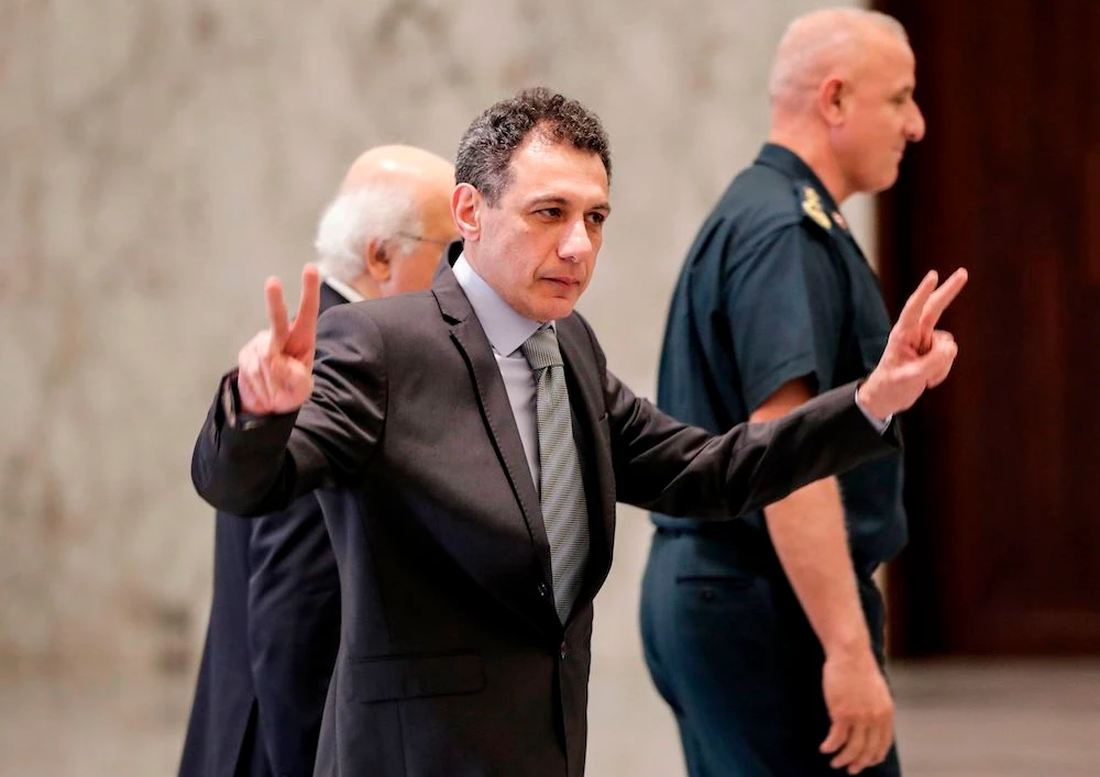 Nizar Zakka, a Lebanese national and US resident arrested in 2015 and sentenced to 10 years in jail on espionage charges, flashes the victory gesture at the presidential palace in Baabda, east of the capital Beirut. (AFP)