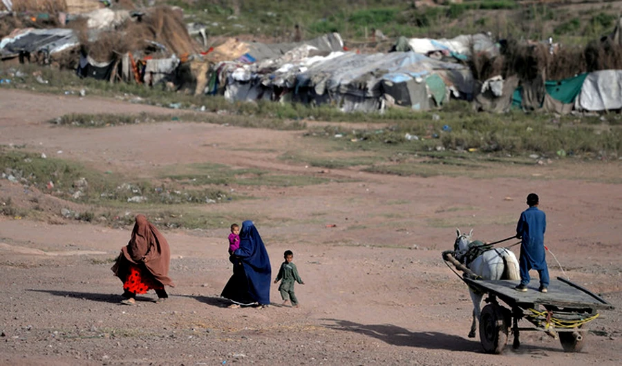 Afghan refugee family walk at a refugee camp on the outskirts of Islamabad. (AFP)