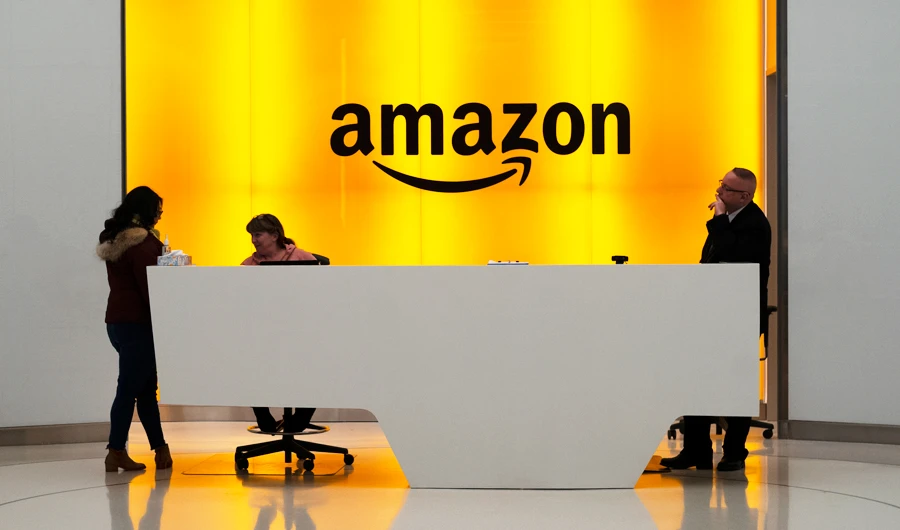 In this Feb. 14, 2019, file photo people stand in the lobby for Amazon offices in New York. (AP)