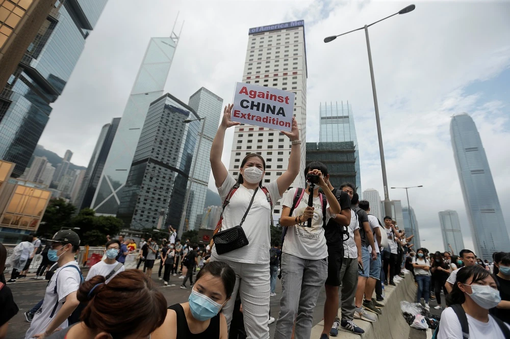A protester holds up a placard reading ‘Against China extradition’ during a demonstration against a proposed extradition bill in Hong Kong on Wednesday, June 12, 2019. (Reuters)
