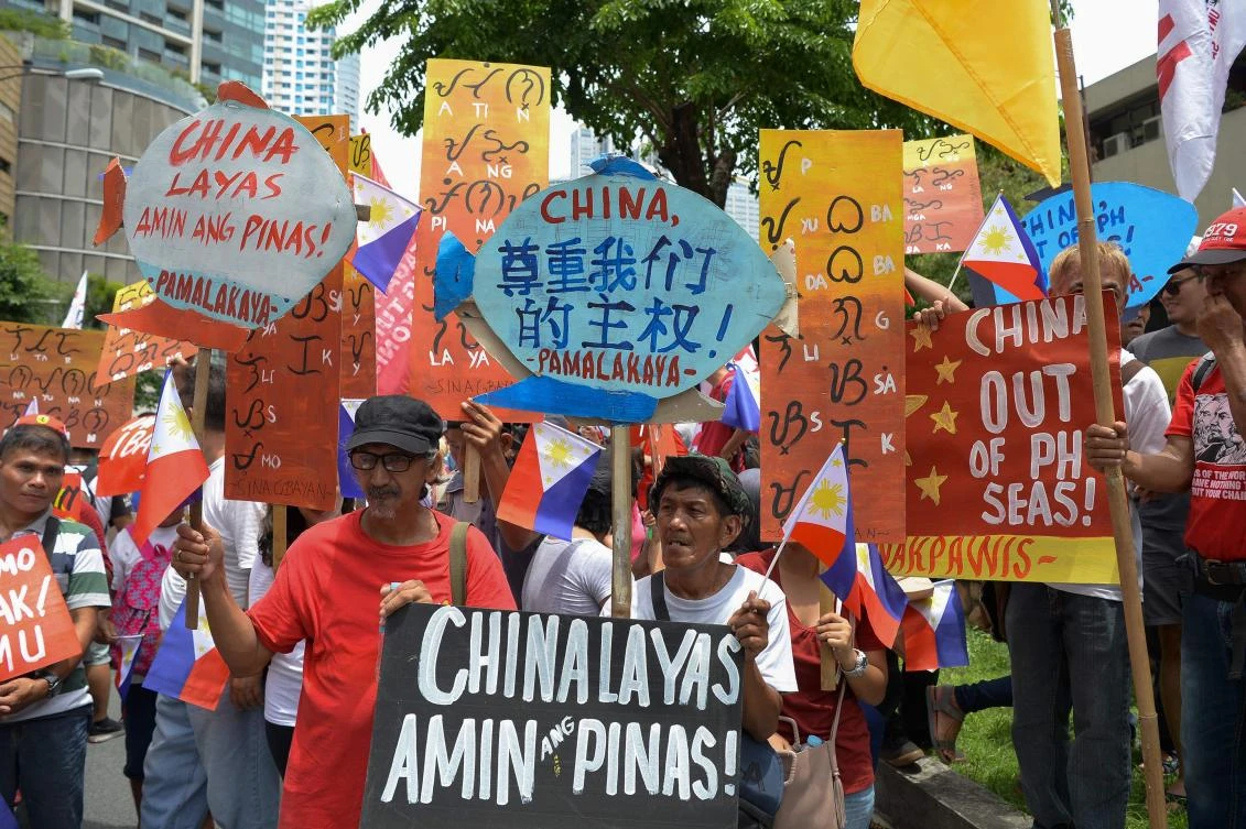 Activists hold placards with anti-China slogans during a protest in front of the Chinese consulate in Manila on Wednesday, June 12, 2019. (AFP)