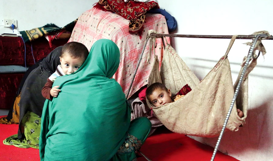 Members of an Afghan family who fled their village in Nangarhar province at their temporary home in Jalalabad. (AP)