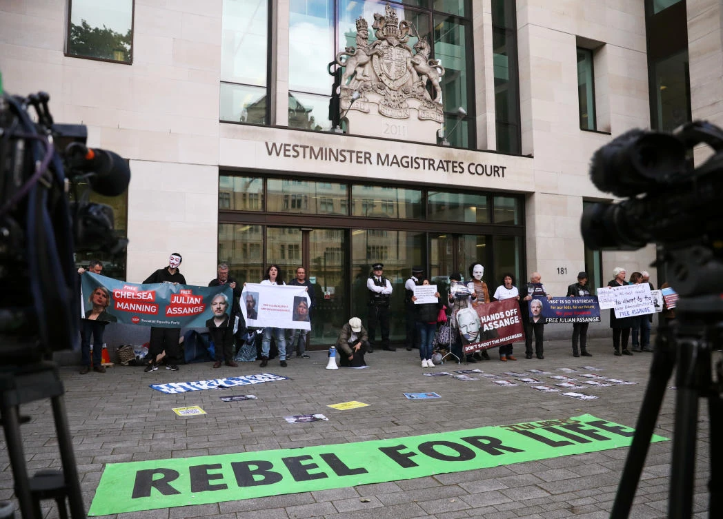 Demonstrators protest outside of Westminster Magistrates Court, where a case hearing for US extradition of Wikileaks founder Julian Assange is held, in London, Britain, June 14, 2019. (Reuters)
