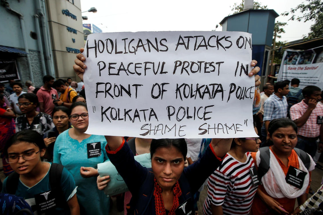 A doctor holds a placard at a government hospital during a strike demanding security after the recent assaults on doctors by the patients' relatives, in Kolkata, India, June 14, 2019. (Reuters)