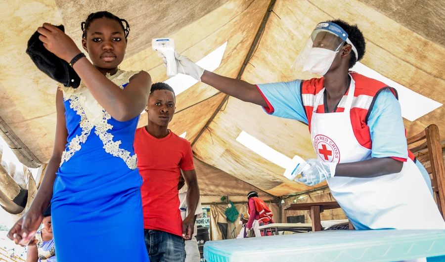 People coming from Congo have their temperature measured to screen for symptoms of Ebola, at the Mpondwe border crossing with Congo, in western Uganda Friday, June 14, 2019. (AP)
