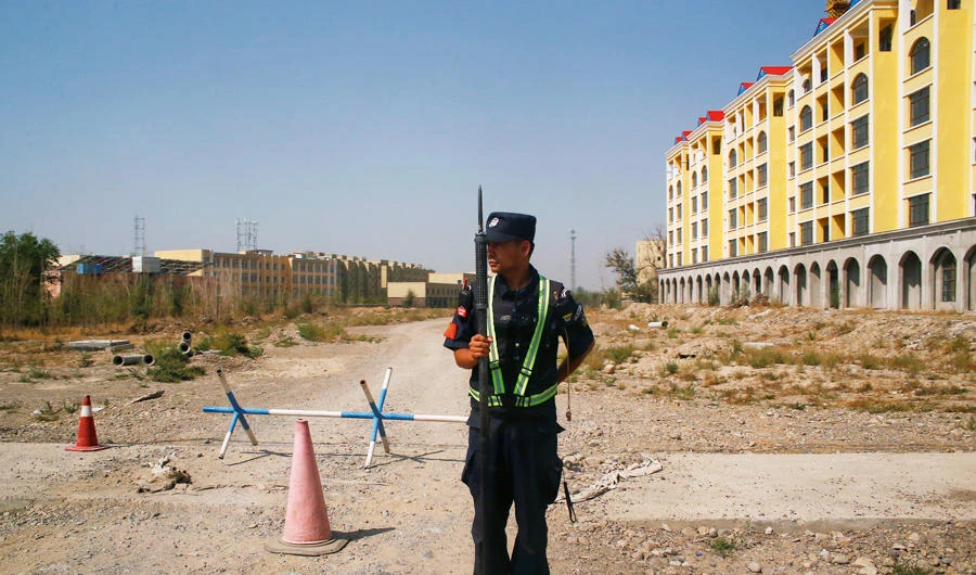 A Chinese police officer takes his position by the road near what is officially called a vocational education centre in Yining in Xinjiang Uighur Autonomous Region, China September 4, 2018. (REUTERS)