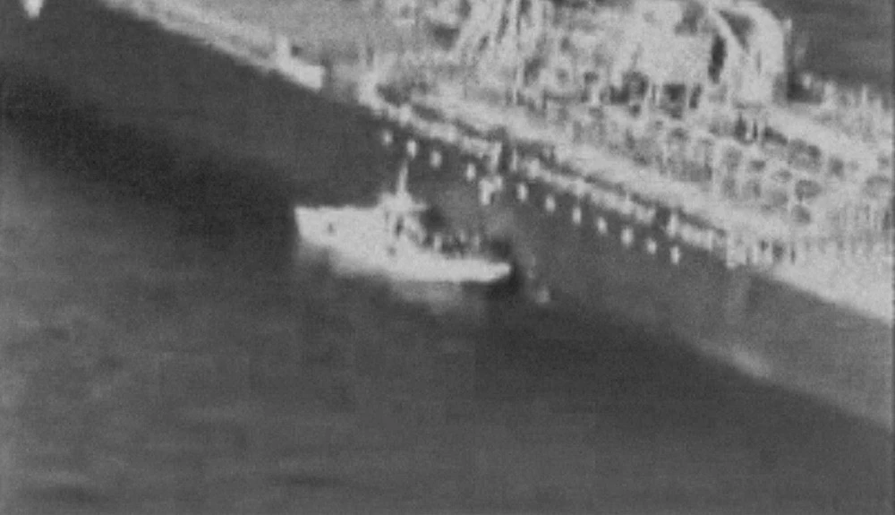 A video released by the US Central Command (USCENTCOM) on June 13, 2019, reportedly shows an Iranian navy patrol boat in the Gulf of Oman approaching the Japanese operated methanol tanker Kokuka Courageous and removing an unexploded mine. (AFP)