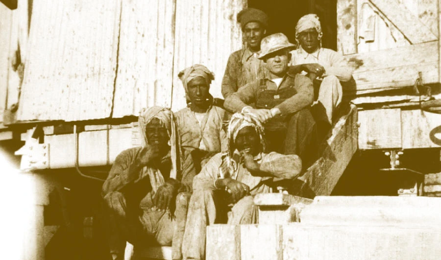 The drilling crew of Dammam Well No. 7 pose on the steps of the rig, where drilling for oil began in 1935. Three years later, oil was struck here on March 4, 1938. (Saudi Aramco)
