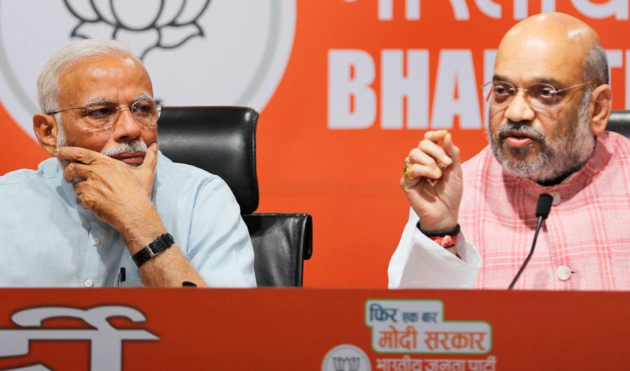 Indian Prime Minister Narendra Modi listens to Bharatiya Janata Party (BJP) President Amit Shah speak during a press conference at the party headquarters in New Delhi, India, Friday, May 17, 2019. (AP)