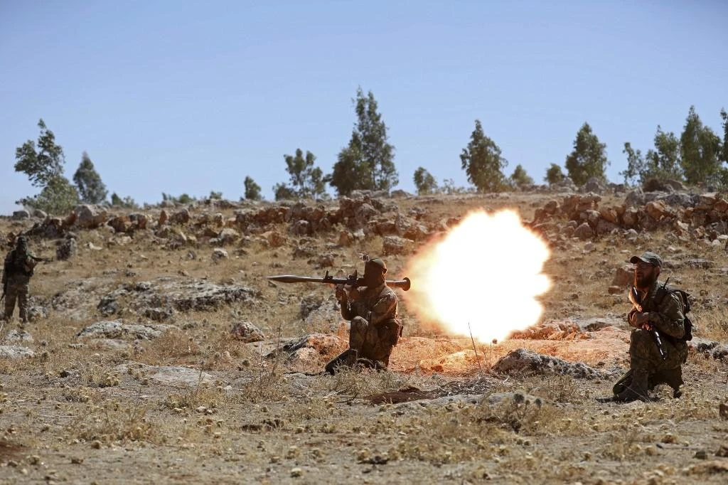 A Syrian fighter fires a rocket-propelled grenade during a graduation of new Hayat Tahrir Al-Sham members at a camp in the countryside of the northern Idlib province on August 14, 2018. (AFP file photo)