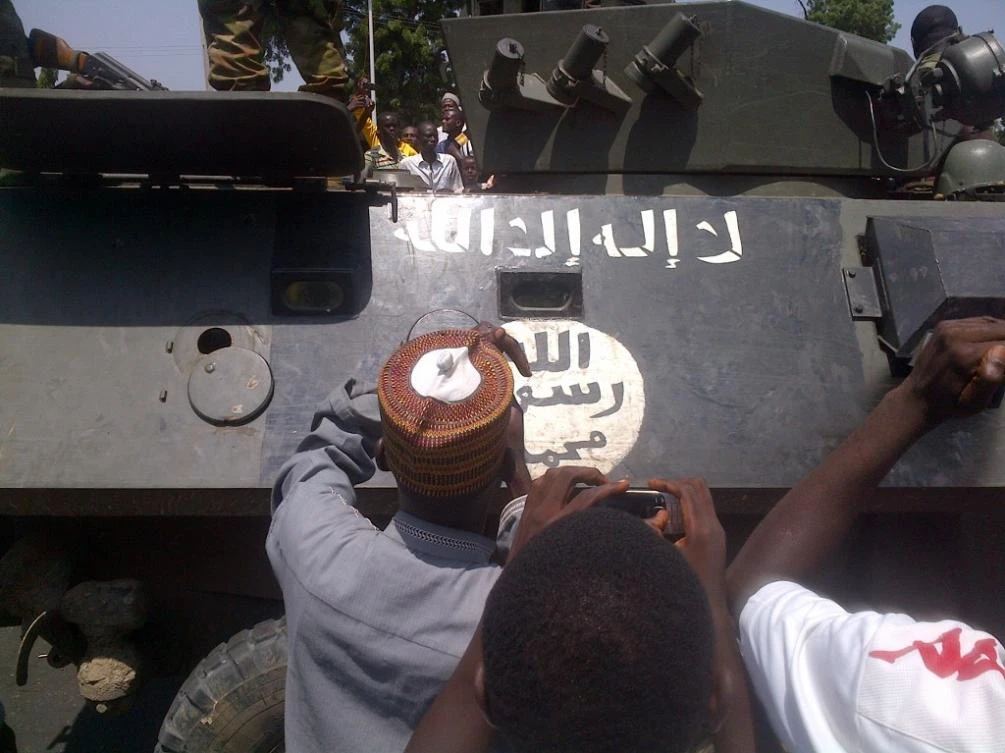 Above, residents gather around an armored personnel carrier recovered by the Nigerian army from Boko Haram insurgents in Konduga in this September 16, 2014 photo. (AFP file photo)